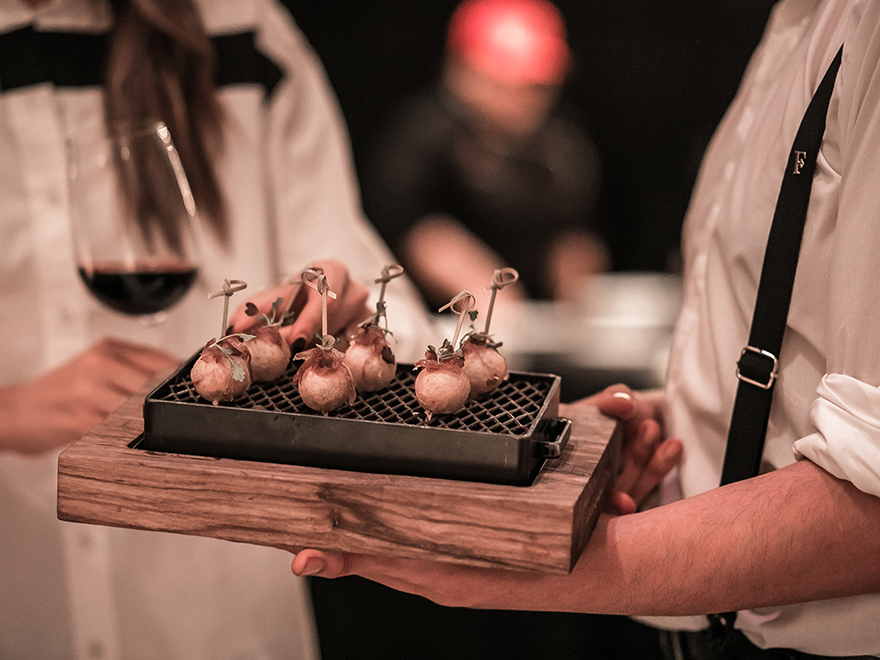 Un mozo ofreciendo canapés a los invitados